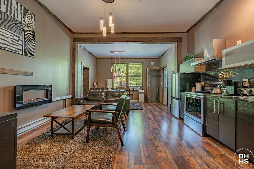 a kitchen and living room with a table and a couch at Downhill Lodge Condominium in Lake Placid
