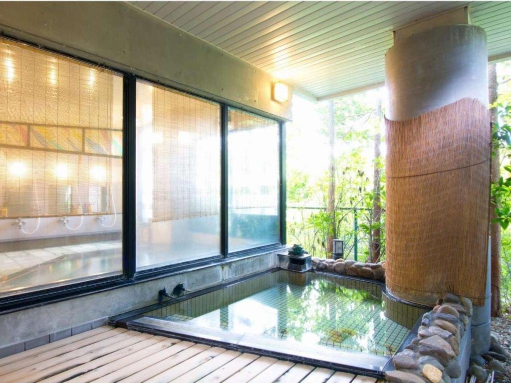 - une piscine dans une maison avec fenêtres dans l'établissement Yamaichi, à Shizukuishi