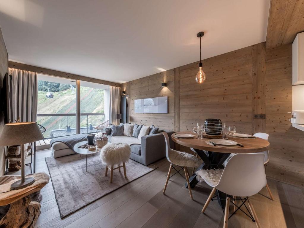 a living room with a couch and a table at Appartement moderne Courchevel 1550, 4 personnes, parking, wifi - FR-1-631-234 in Courchevel