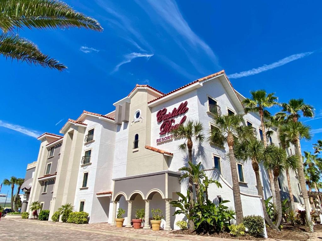 a hotel with palm trees in front of it at Castillo Real St Augustine Beach,Tapestry Collection Hilton in Saint Augustine Beach