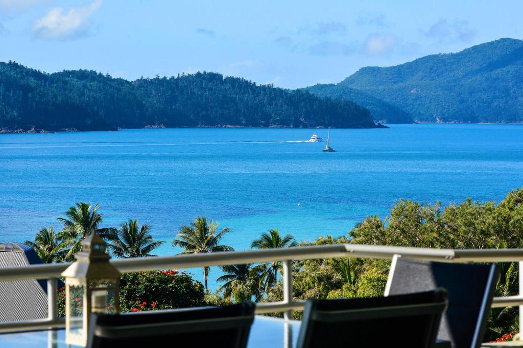 a view of the ocean from the balcony of a resort at Poinciana Lodges in Hamilton Island