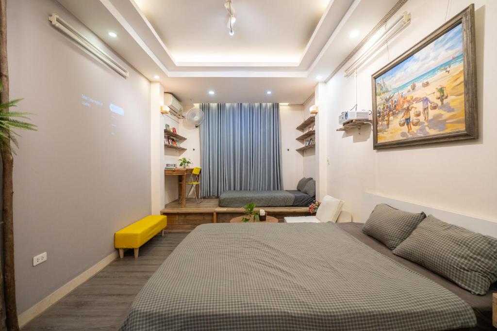 a bedroom with a bed and a yellow stool at Homestay Nhacuabu in Hanoi