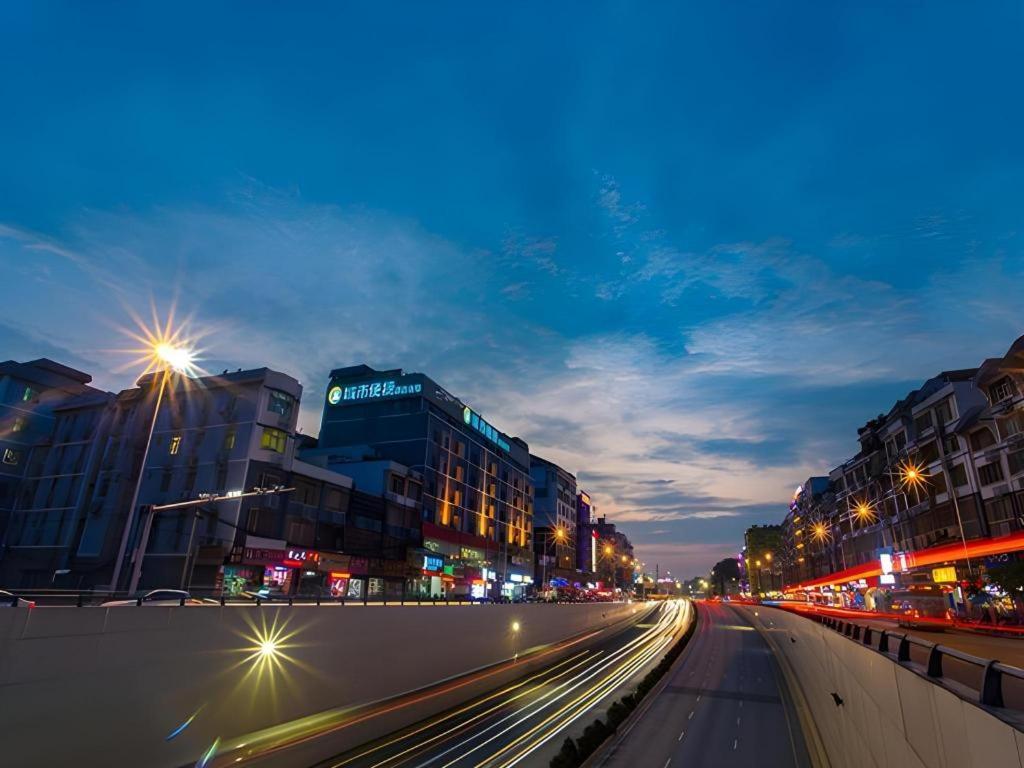a city street with buildings and street lights at night at City Comfort Inn Nanning Dashatian Metro Station in Nanning