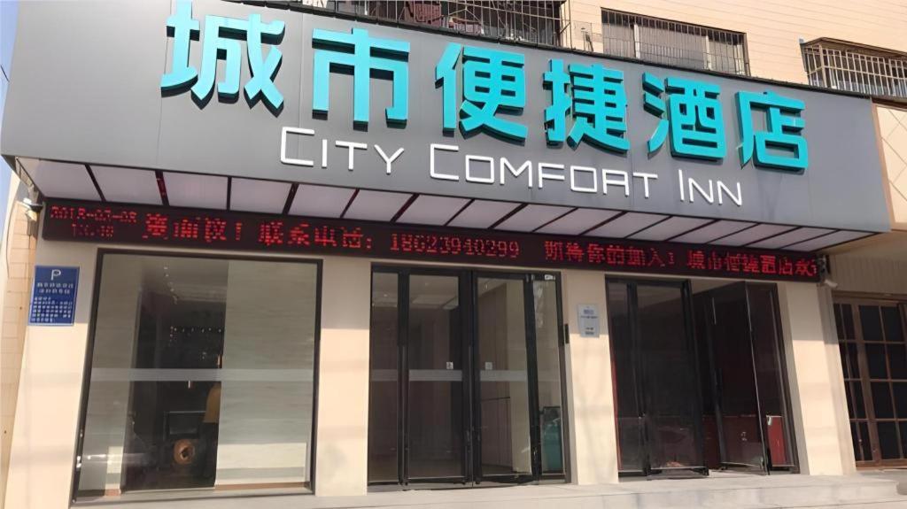 een bordje 'corrupte instelling' op de gevel van een gebouw bij City Comfort Inn Zhoukou City Chuanhui District Huanghe Road in Zhoukou