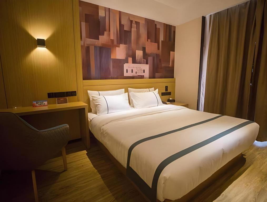 Ένα ή περισσότερα κρεβάτια σε δωμάτιο στο City Comfort Inn Laibin Wuxuan Yuda