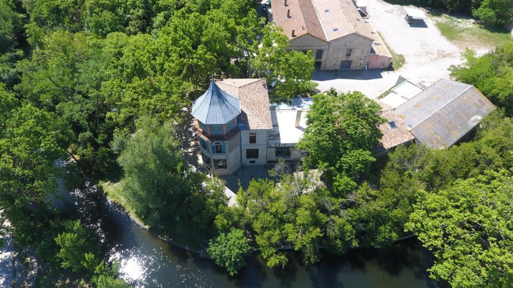 an aerial view of a house on a river at Château de Livière in Calvisson