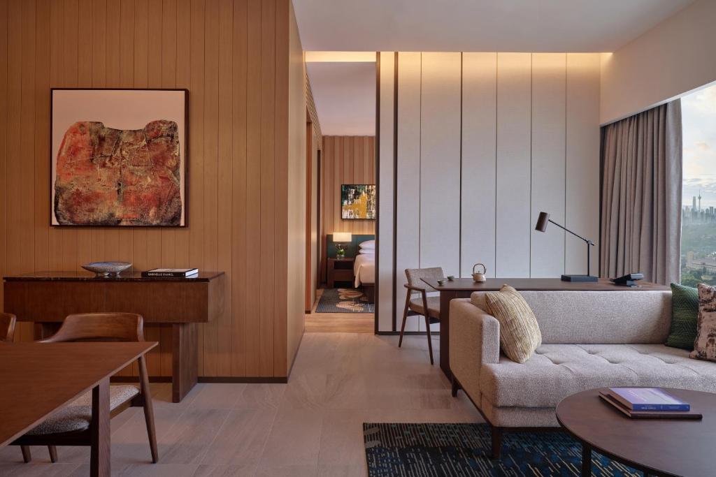 A refined sitting area connects to a bedroom and a skyline-facing window.