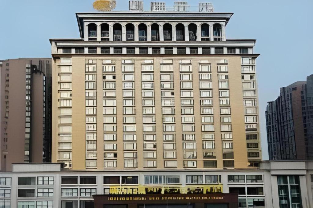 a large building with a tower on top of it at New Century Pujiang Hotel in Xiajizhai