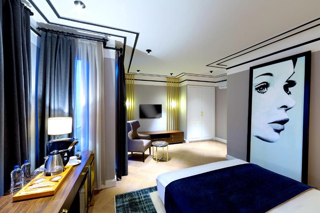 a hotel room with a bed and a desk and a room at Walton Hotels Galata in Istanbul