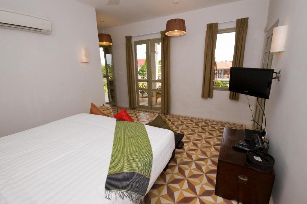 Postel nebo postele na pokoji v ubytování Bambu Hotel