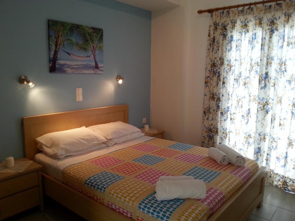 a bedroom with a bed with two towels on it at Katerina Studios in Paleokastritsa