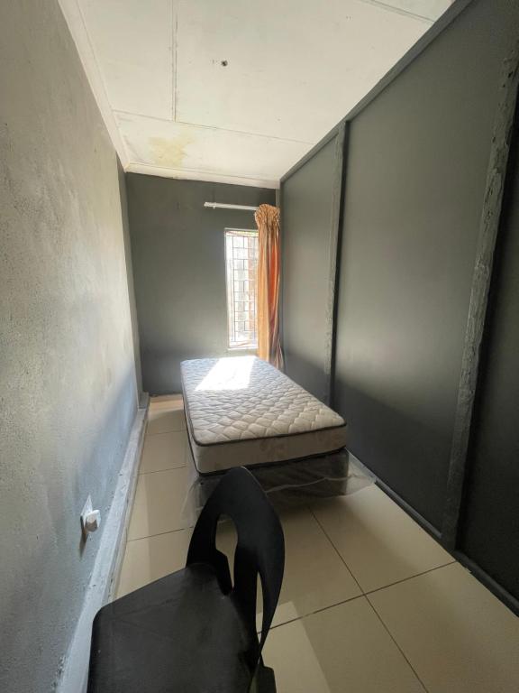 Ένα ή περισσότερα κρεβάτια σε δωμάτιο στο Mbombela Guesthouse
