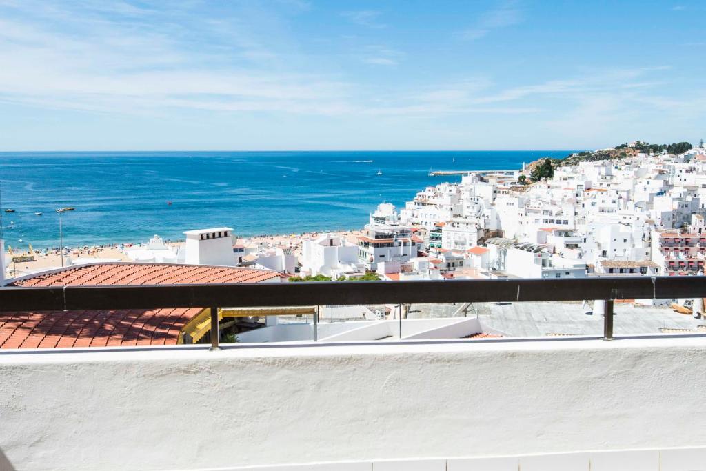 a view of a city from a balcony with the ocean at Apartamentos Tio Papel in Albufeira