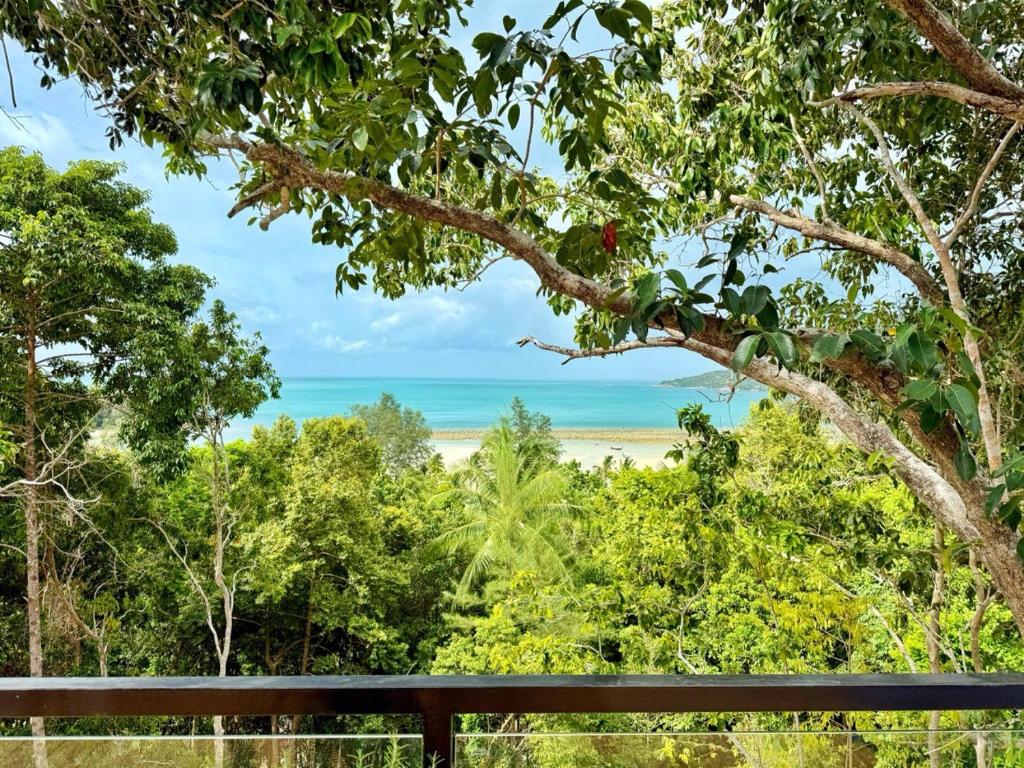 a view of the beach from the deck of a house at Escape Villa 2-Bedroom Luxury Retreat with Private Pool & Sea View in Mae Haad