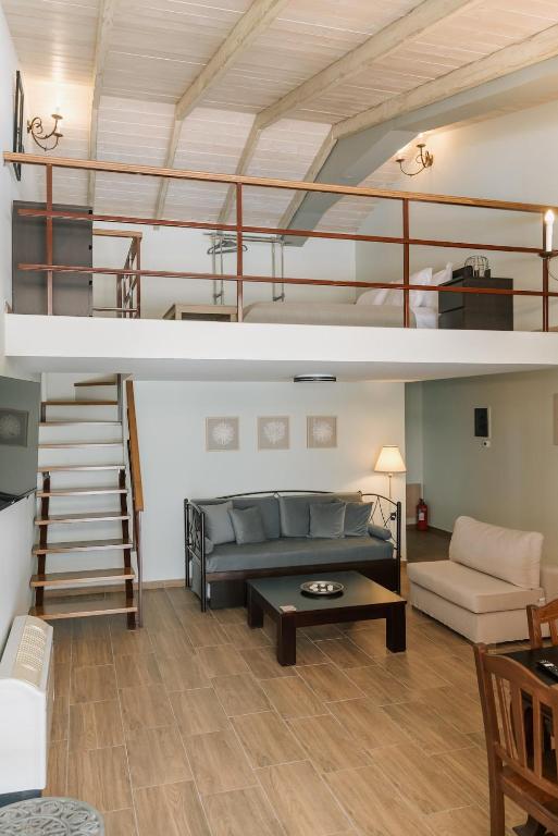 a living room with a loft bed and a couch at LOTOS Families Apartments 2 in Konitsa