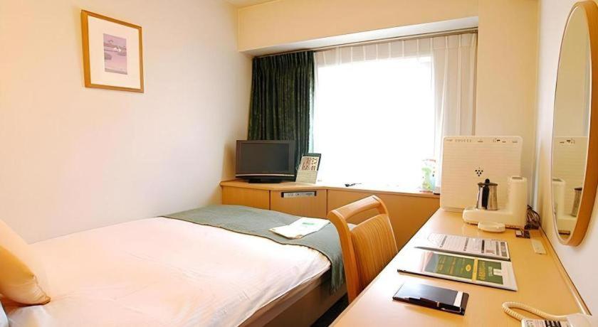 Ένα ή περισσότερα κρεβάτια σε δωμάτιο στο Kushiro Royal Inn