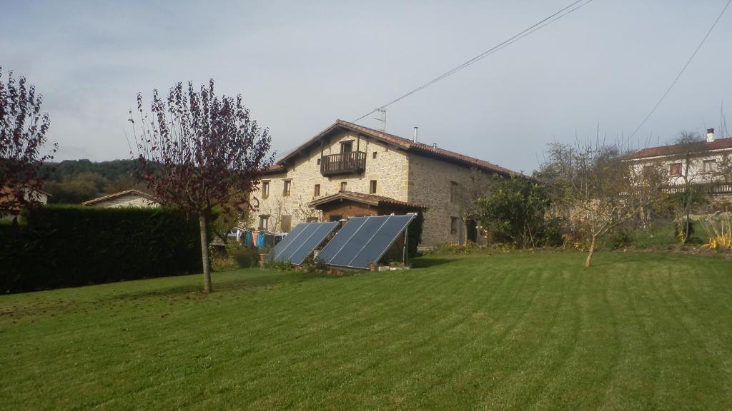 un patio con una casa con paneles solares en Izpiliku, en Acosta