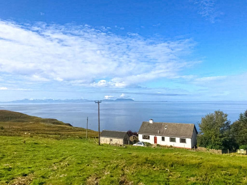 a house in a field with a view of the ocean at Sunny Hill - Ukc6884 in Aultgrishin
