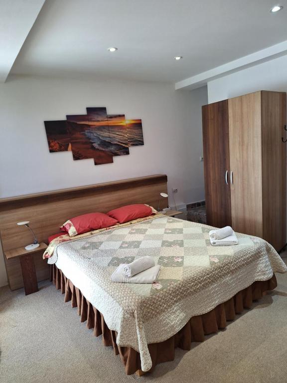 a bedroom with a large bed with red pillows at Villa 3 papuci in Constanţa