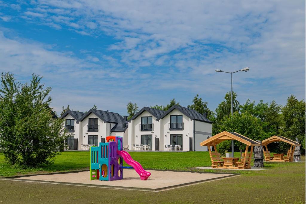 a playground in front of a house with a slide at Słoneczna Zatoka in Władysławowo