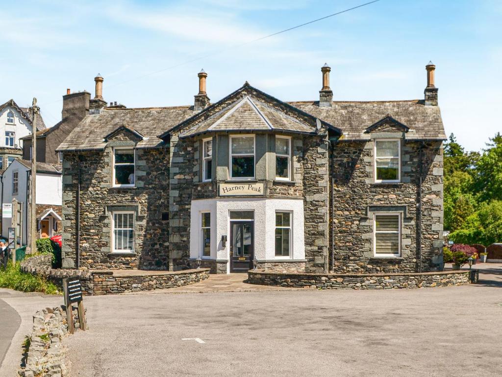 a large stone house with a white front door at 4 Harney Peak in Portinscale
