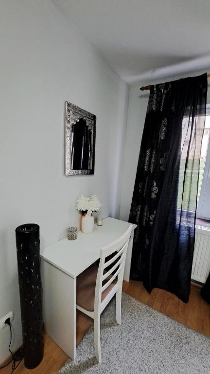 a white desk in a room with a window at Dani Cute in Vaslui