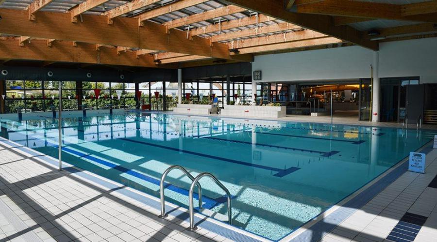 a large swimming pool with chairs in a building at jolie maison de pêcheurs in Palavas-les-Flots