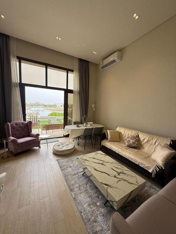 a living room with a couch and a table at Ocean Breeze Hawana in Salalah