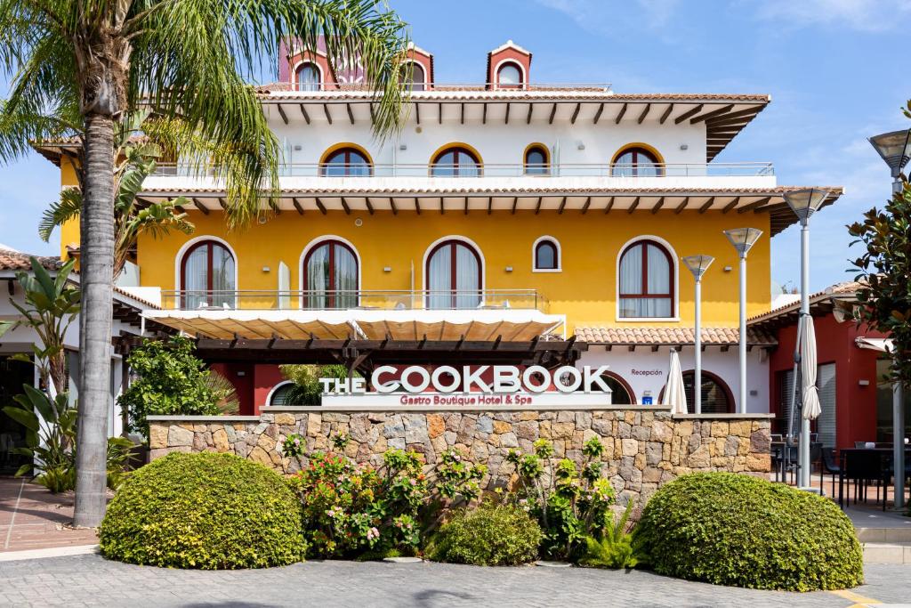 a building with a google book sign in front of it at The Cookbook Gastro Boutique Hotel & SPA in Calpe