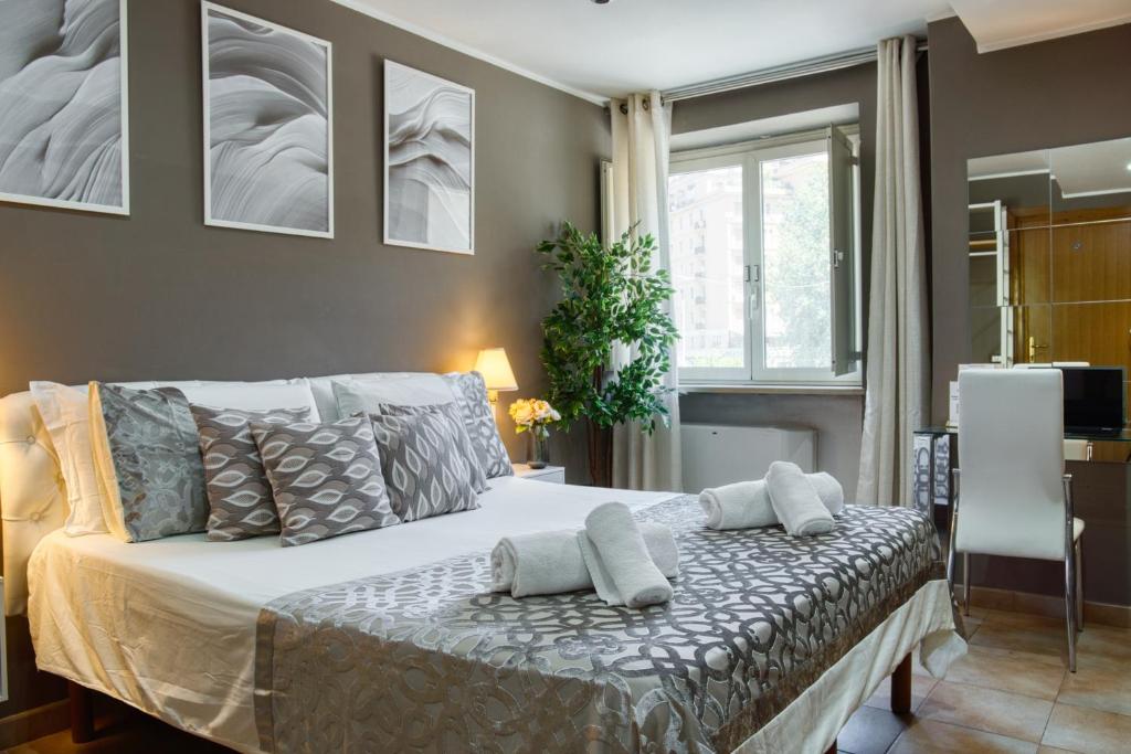 a bedroom with a bed with pillows on it at Di Martino Residence in Rome
