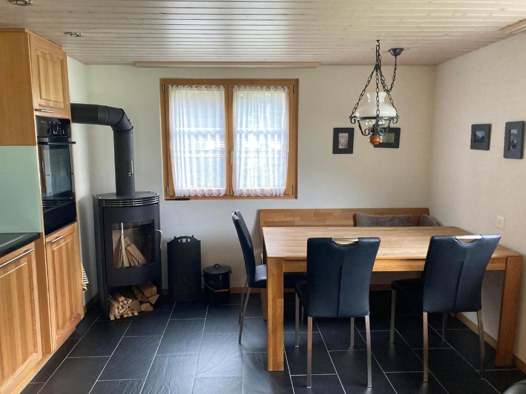 a dining room with a table and a wood stove at Uf em Schloss in Biel