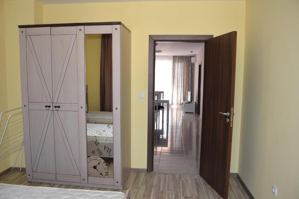 a room with a closet and a door to a bedroom at Admiral Plaza Apartments in Sunny Beach