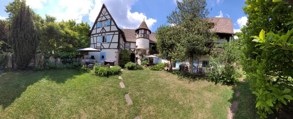 a large house with a yard in front of it at Maison Kobold XVIè siècle in Wissembourg