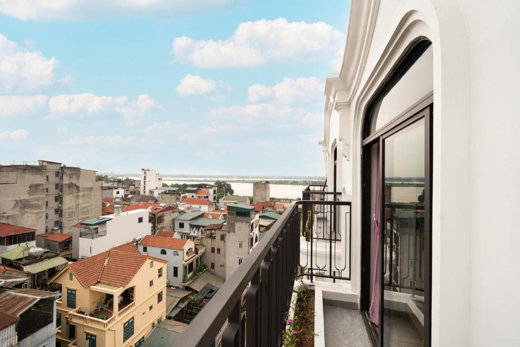 a balcony with a view of a city at The Harmony Red River Residence in Hanoi