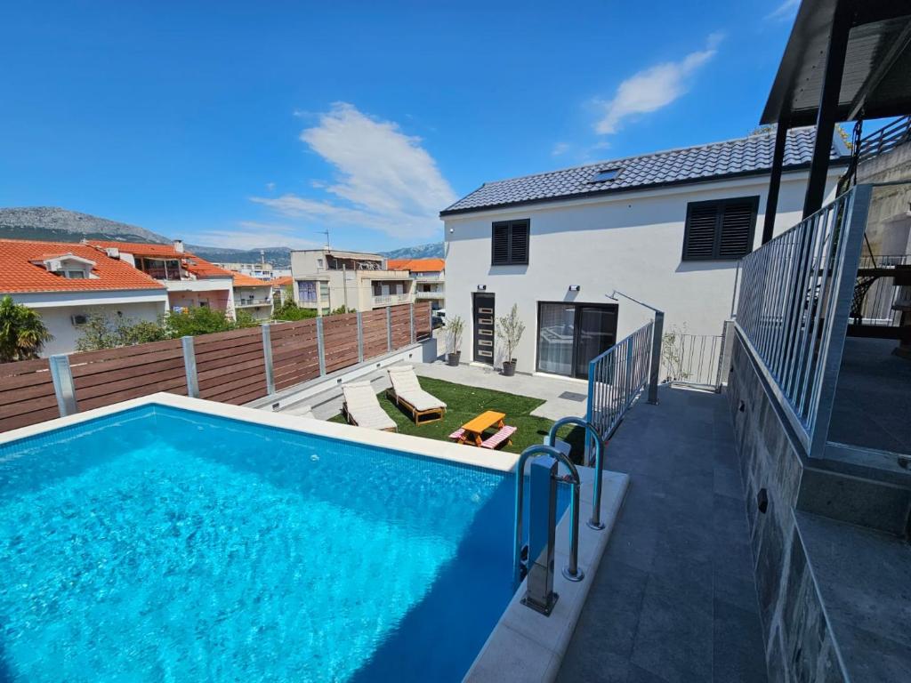 a swimming pool in the backyard of a house at TheTomonina house with pool in Split
