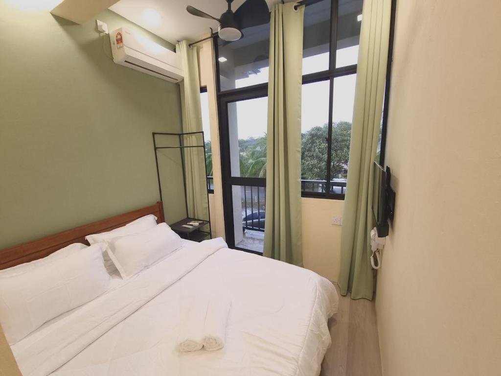 Postel nebo postele na pokoji v ubytování Kenyalang Saberkas Apartment Homestay