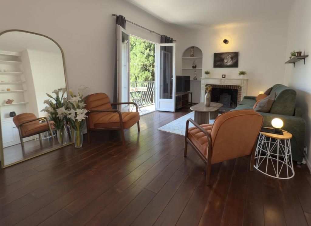 a living room with a couch and chairs and a fireplace at Le Peyrou - Elegant One-Bedroom Apartment for up to 4 Guests - Free Parking - Air Conditioning - Prime City Center Location in Montpellier