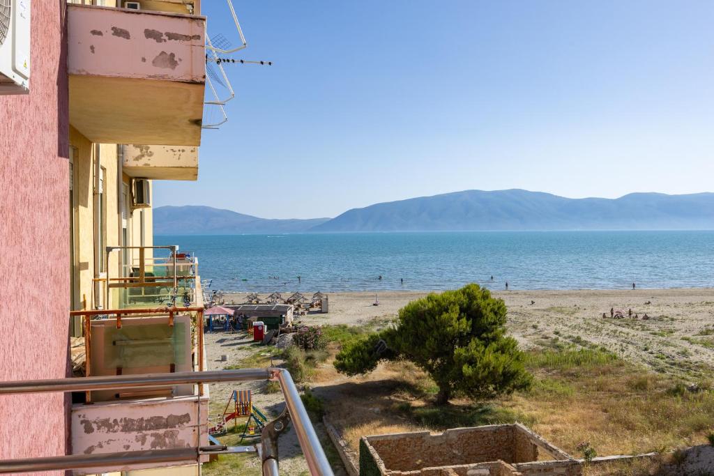 a view of the beach from the balcony of a building at Pomegranate House in Vlorë