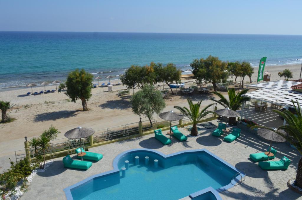 an aerial view of a resort with a pool and the beach at Boutique Giannikis By The Beach in Limenaria