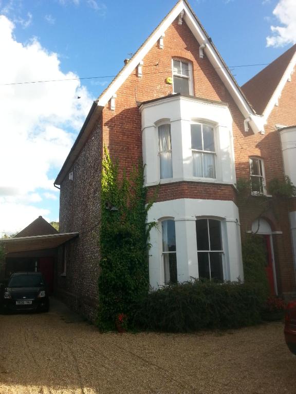 a brick house with a car parked in front of it at Rowlands Castle No 41 in Rowlands Castle