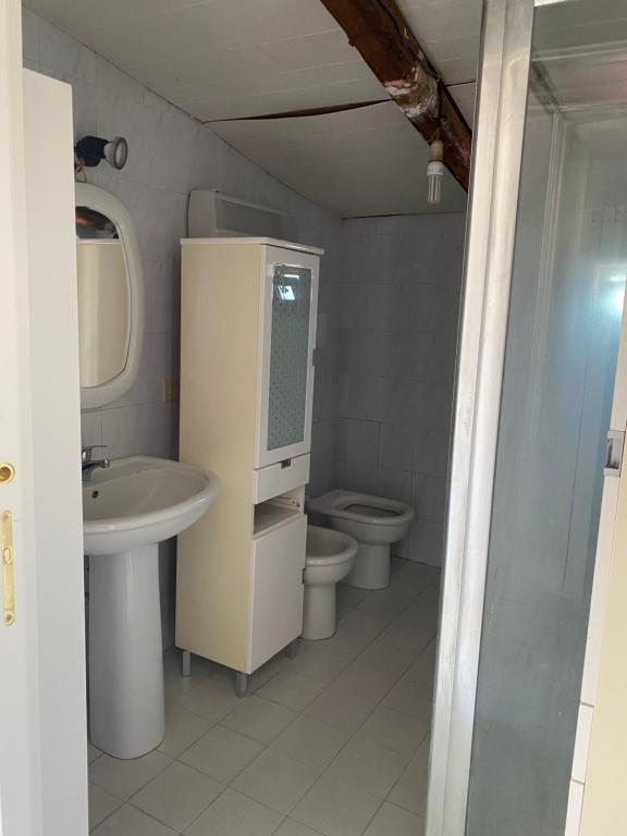 a bathroom with a sink and a toilet at Casa privata in Lido dei Pini