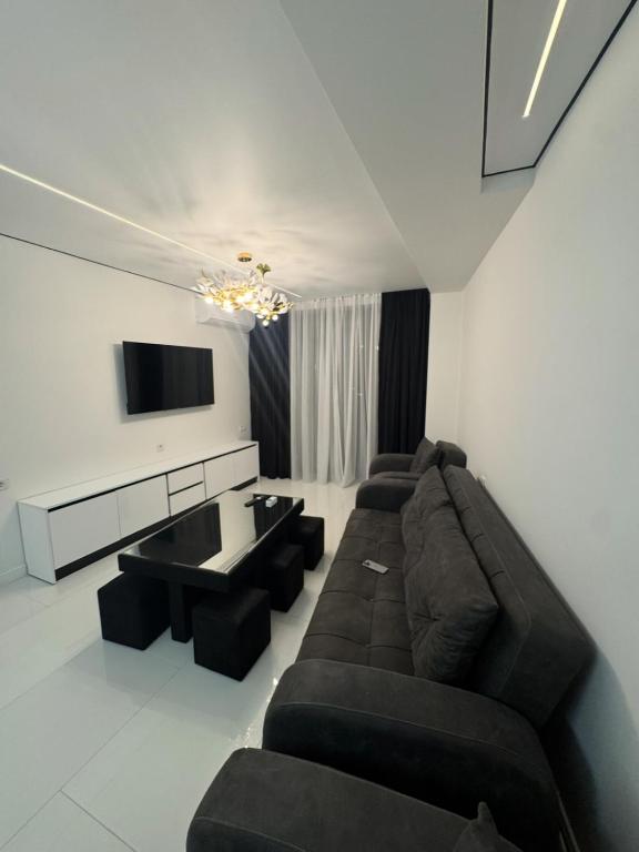 a living room with a couch and a flat screen tv at White Home in K'obulet'i