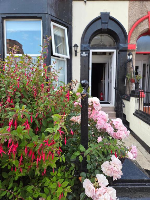 a garden of pink flowers in front of a house at Edenfield Lodge in Blackpool