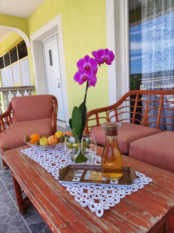 a table with a vase with a flower on it at Apartment Duje Dazlina in Dazlina
