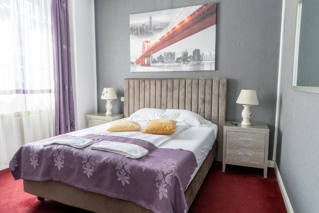 a bedroom with a bed with two pillows on it at Vila 18 Hotel Boutique in Bucharest