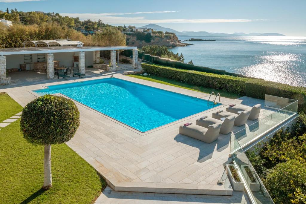 an image of a swimming pool in a villa at Paradise Beachfront Villa Athenian Riviera in Aghia Marina