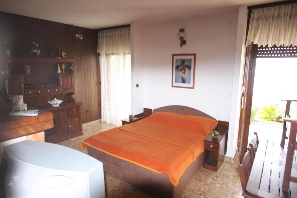 ピサックにあるPisakdream apartmentsのベッドと机と窓のある寝室