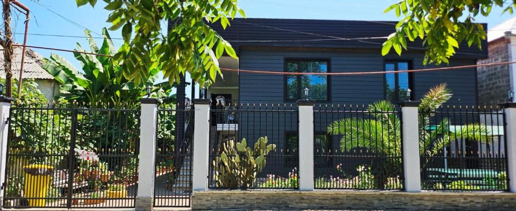a black fence in front of a house at Ios Guest House in Kobuleti
