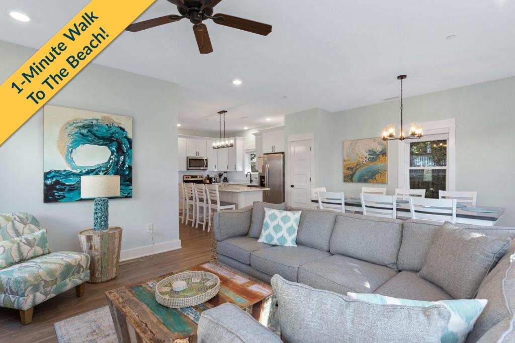 a living room with a couch and a dining room at BCW32A - Sea Escape in Corolla