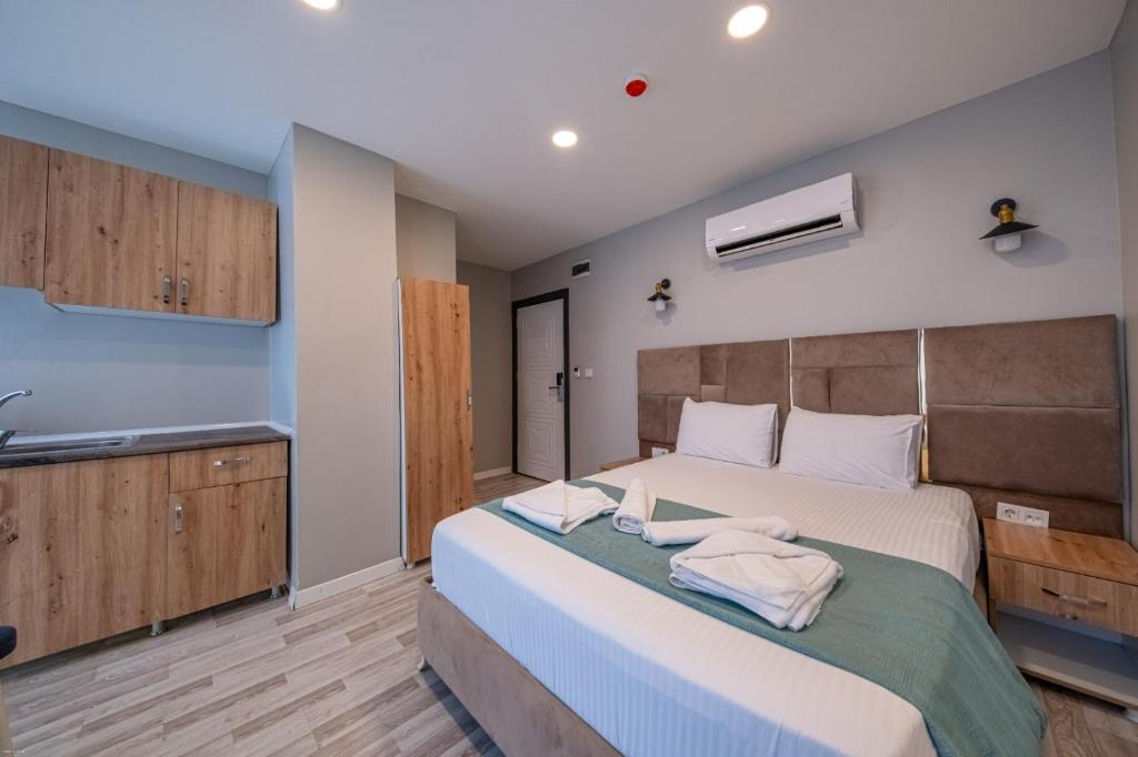 a bedroom with a large bed with towels on it at Casa Nova Hotel in Istanbul